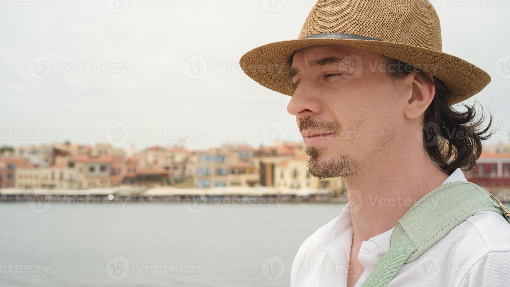 Tourist admiring chania cityscape in crete, greece. a serene travel moment photo