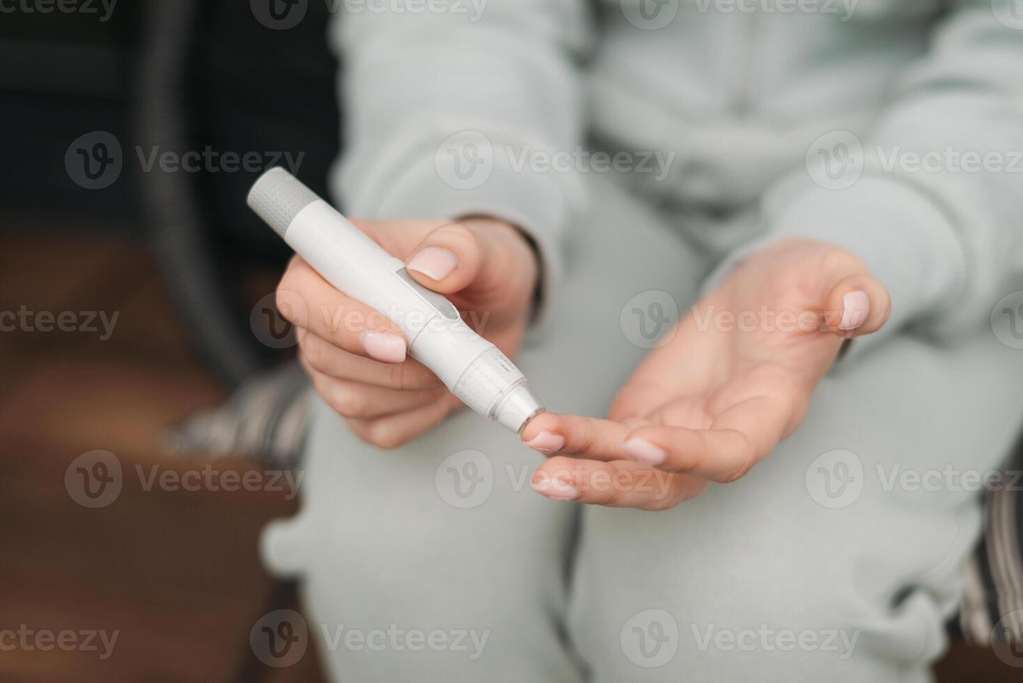 A woman using a glucometer to check blood sugar levels, emphasizing healthcare, diabetes monitoring, and self-care practices close-up photo