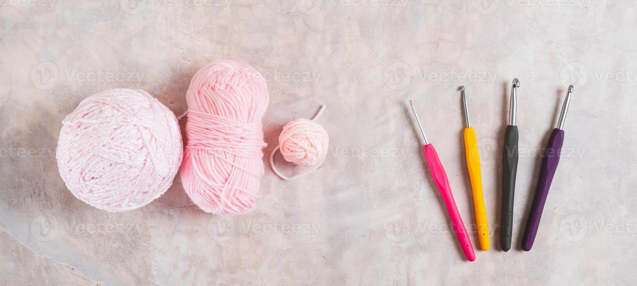 Yarn and tools for a cozy home knitting hobby on the table top view web banner photo