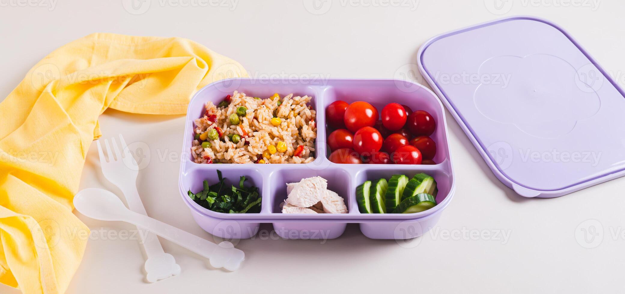 Homemade lunchbox with meat, vegetables and cereals for lunch at work on the table web banner photo