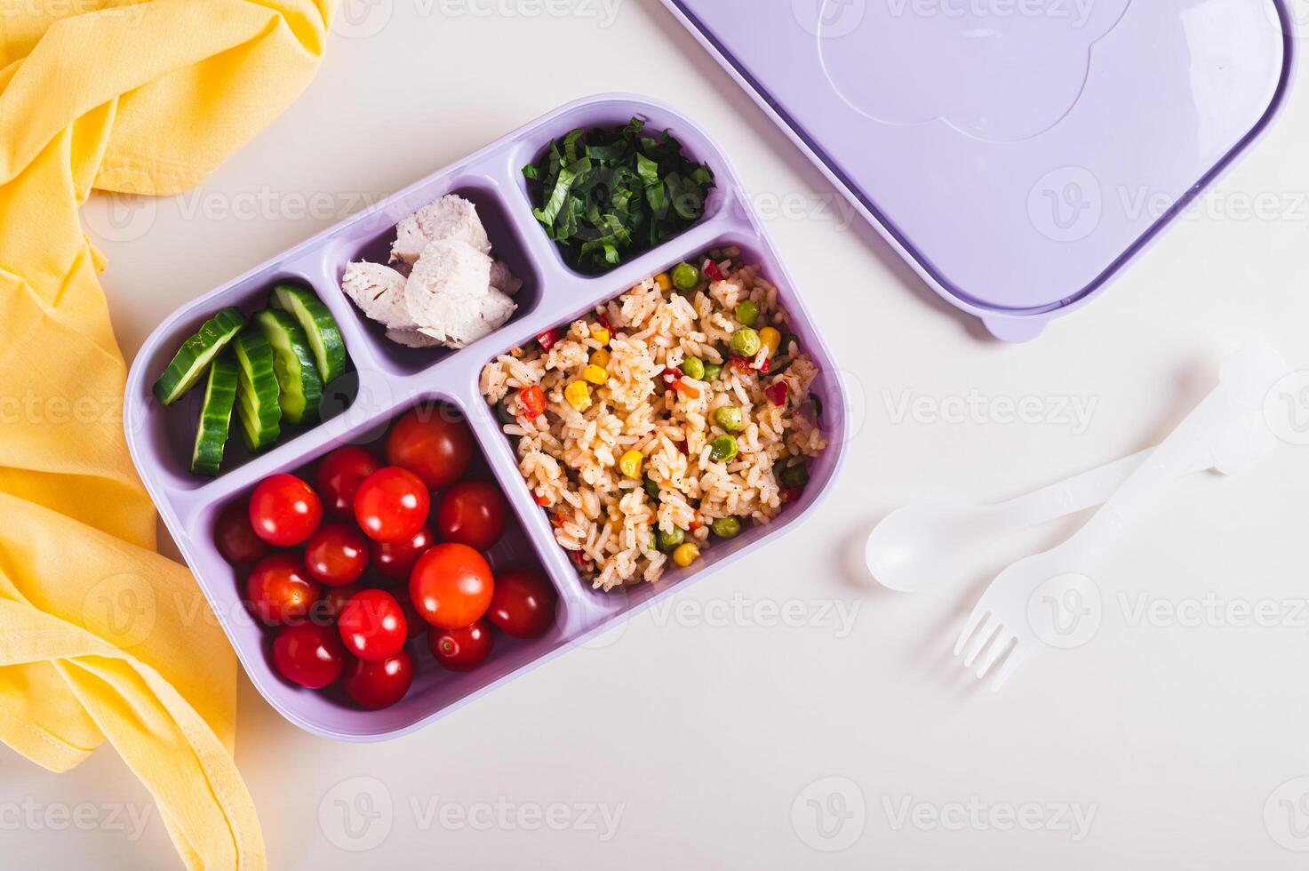 Homemade lunchbox with meat, vegetables and cereals for lunch at work on the table top view photo