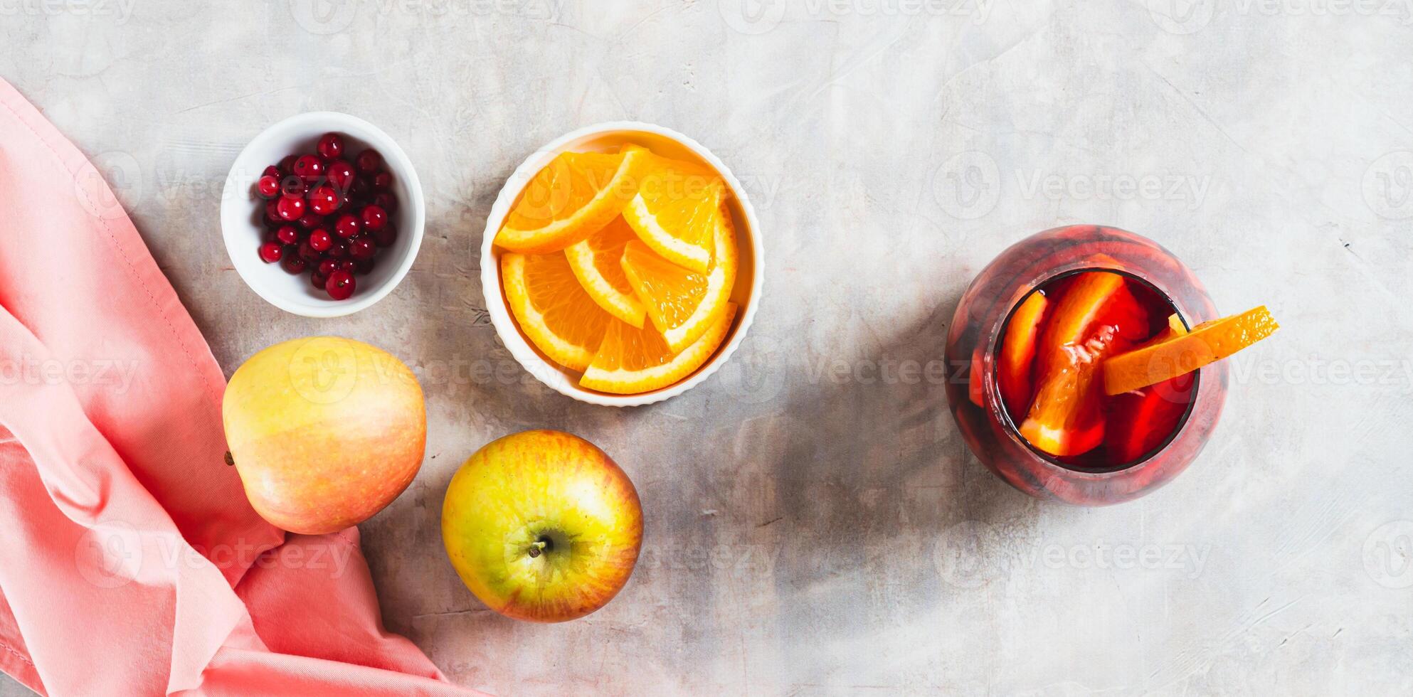 Sangria cocktail with red wine and fruits in glasses on table top view web banner photo