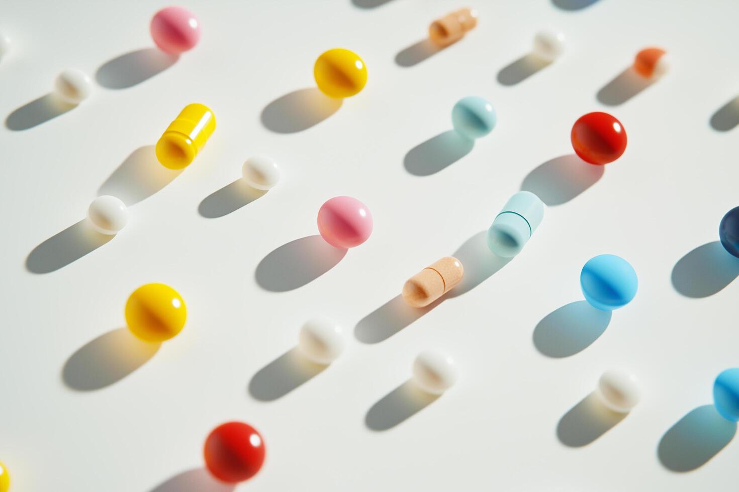 Many different colored pills on a white surface photo