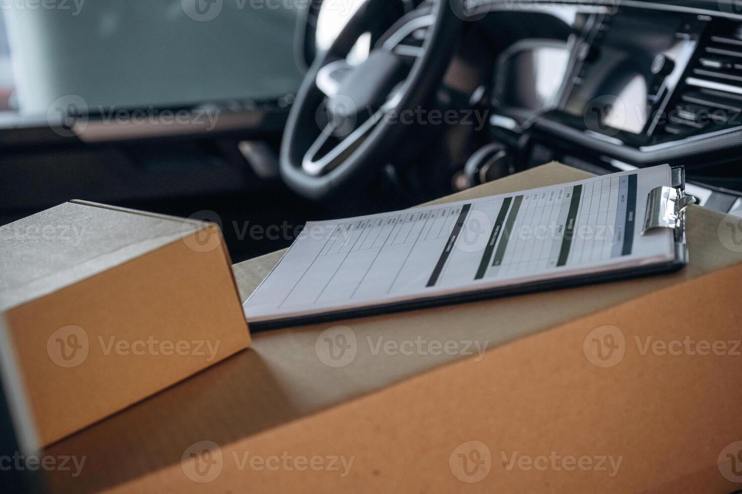 Notepad on boxes,, in the car, conception of delivery photo