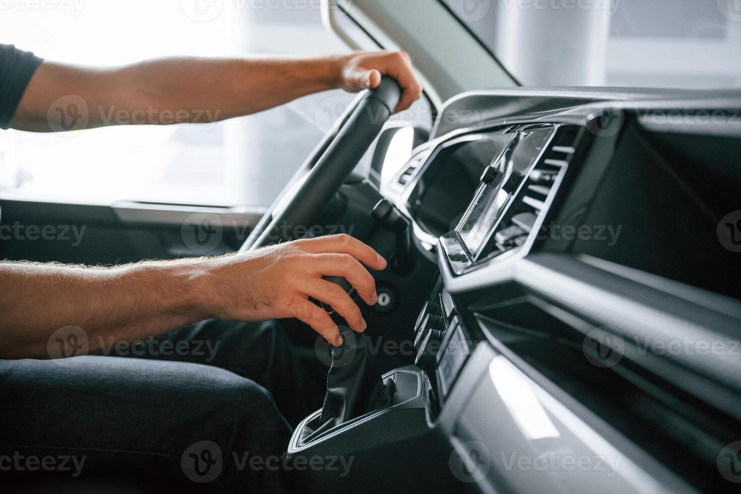 View ,from, the side. Man is sitting in the car, driver photo