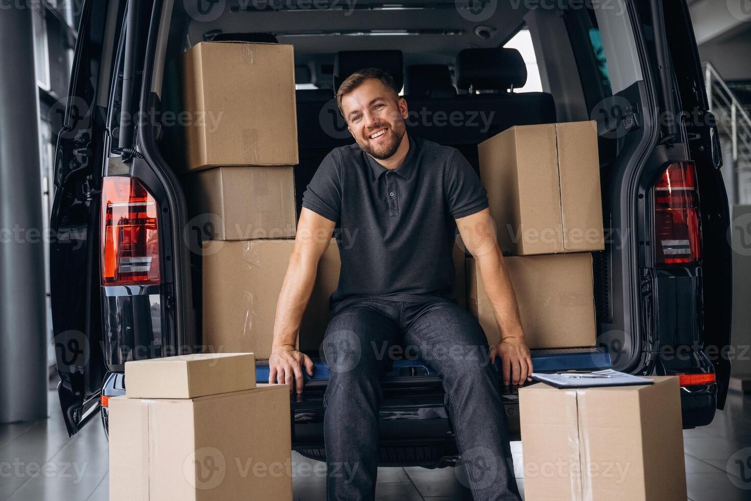 Bunch ,of,, boxes. Delivery man or loader is near the car photo