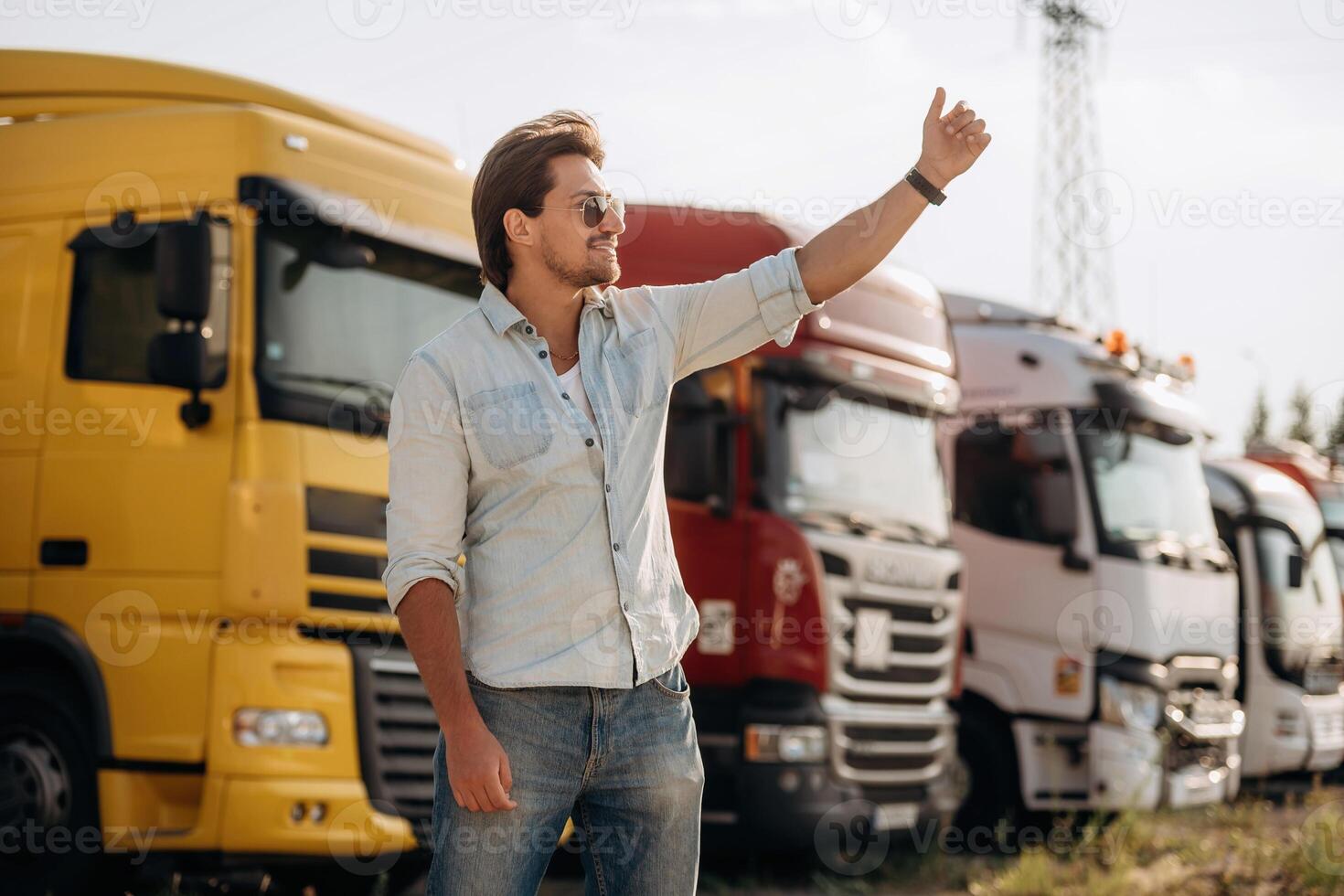 Friendly hand gesture. Truck driver, is, near ,the transport outdoors photo