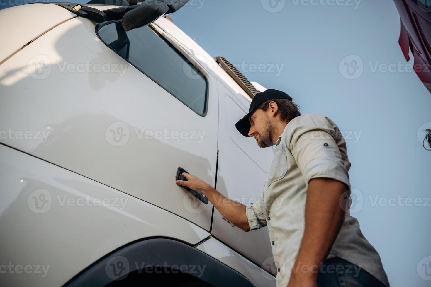 Opening the ,,door. Truck driver is near the transport outdoors photo