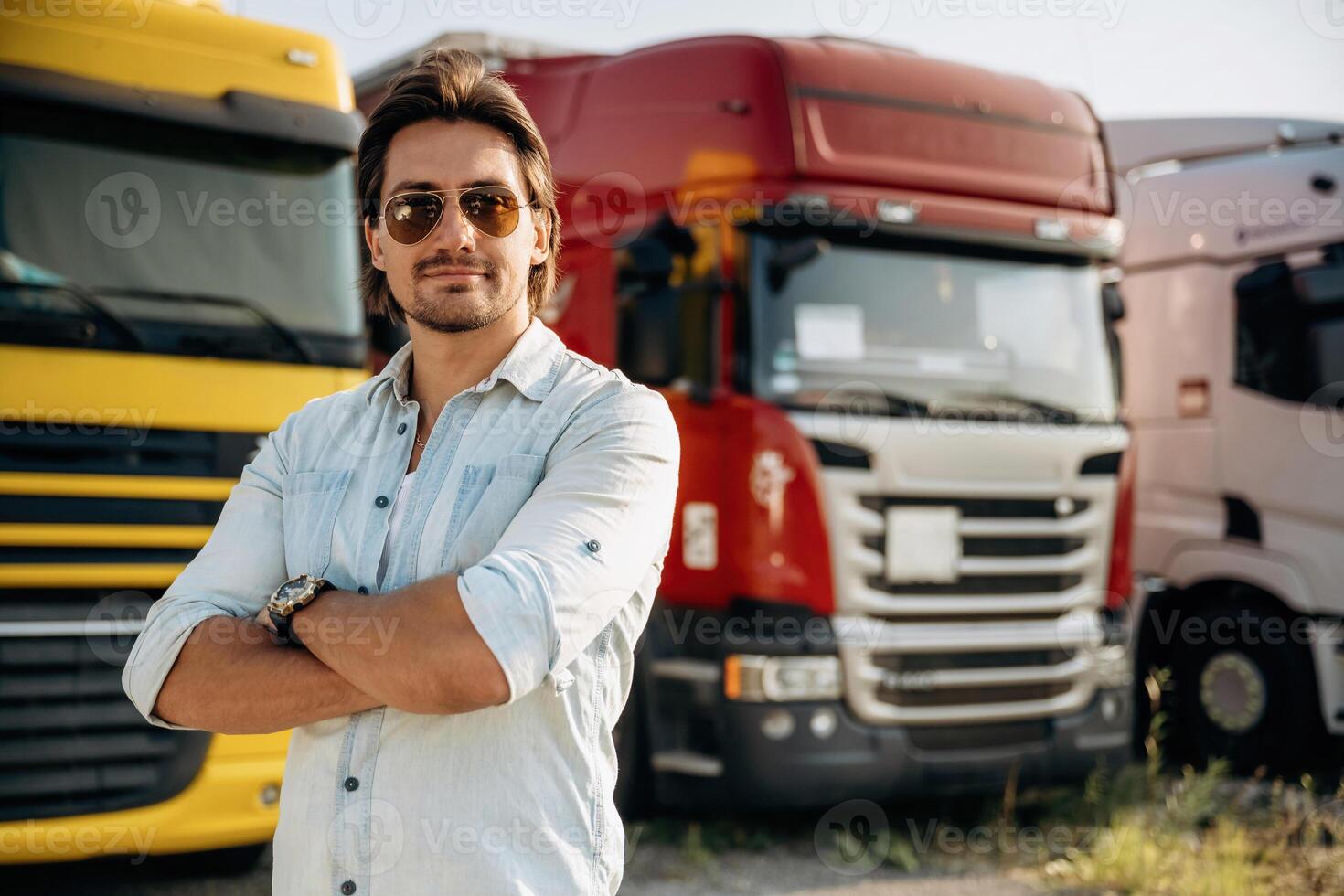 In ,sunglasses... Truck driver is near the transport outdoors photo