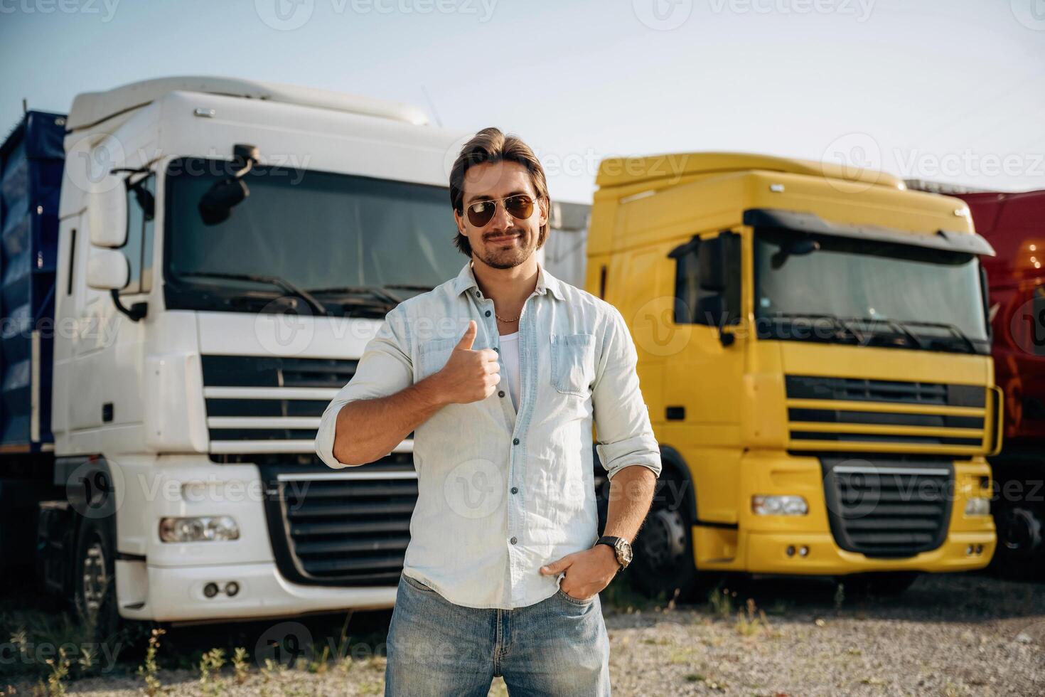 Thumb, up, standing. Truck driver is near the transport outdoors photo