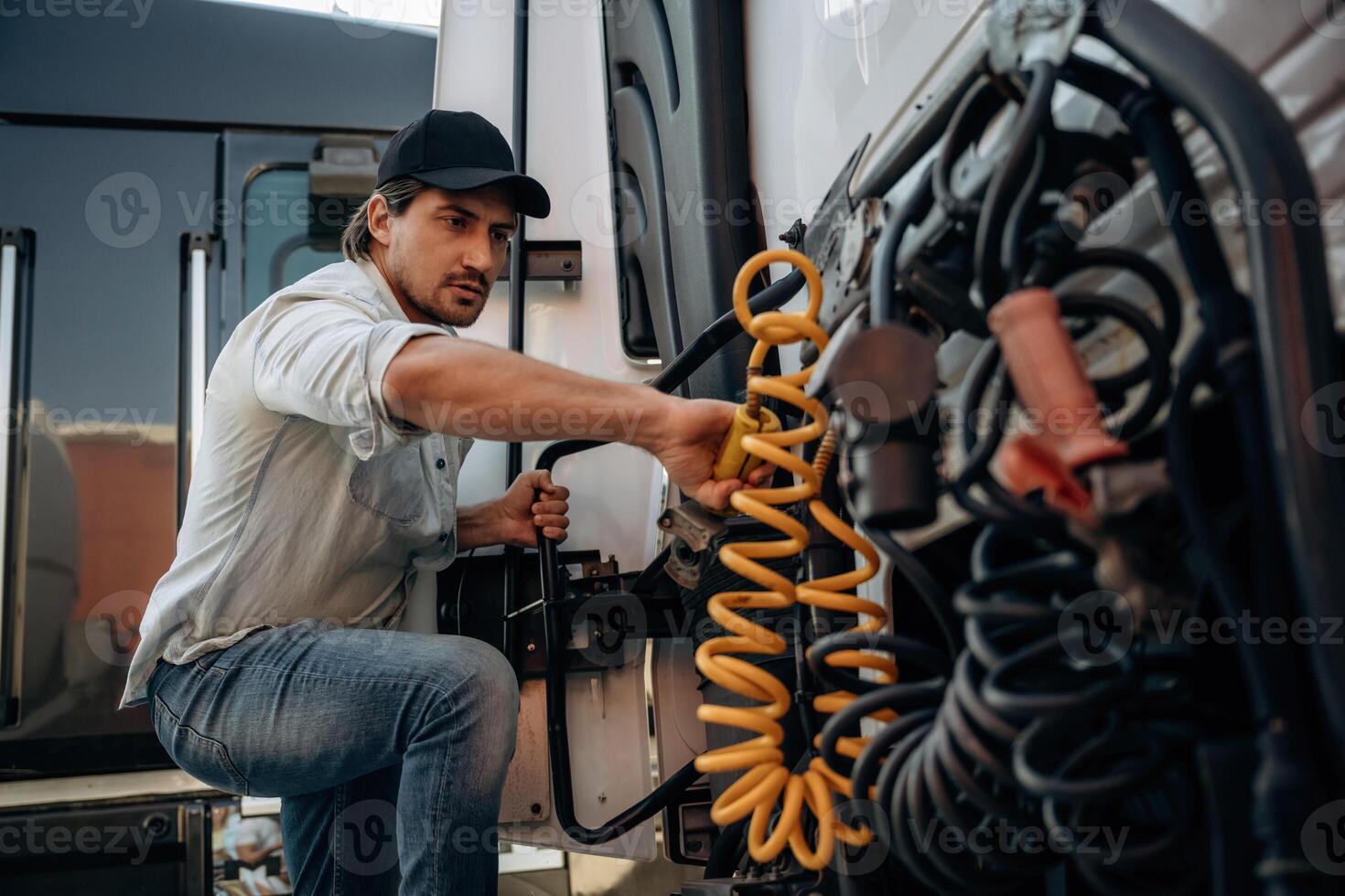 Messing, with ,cables, installation,, fix. Truck driver is near the transport outdoors photo