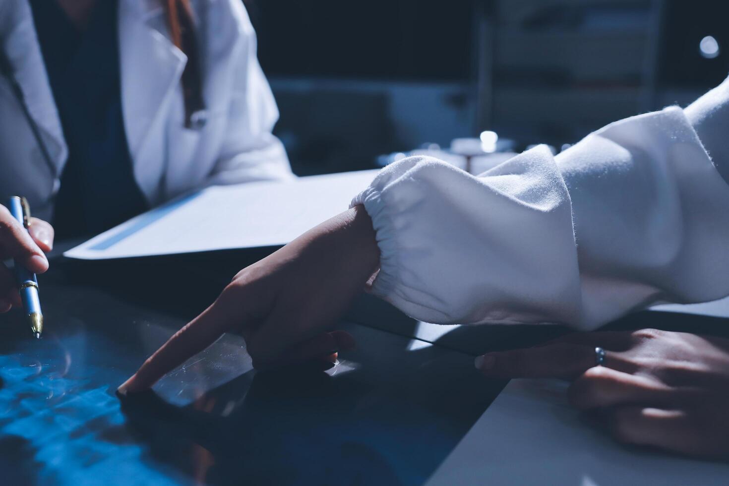 Two doctors are working on a computer screen photo