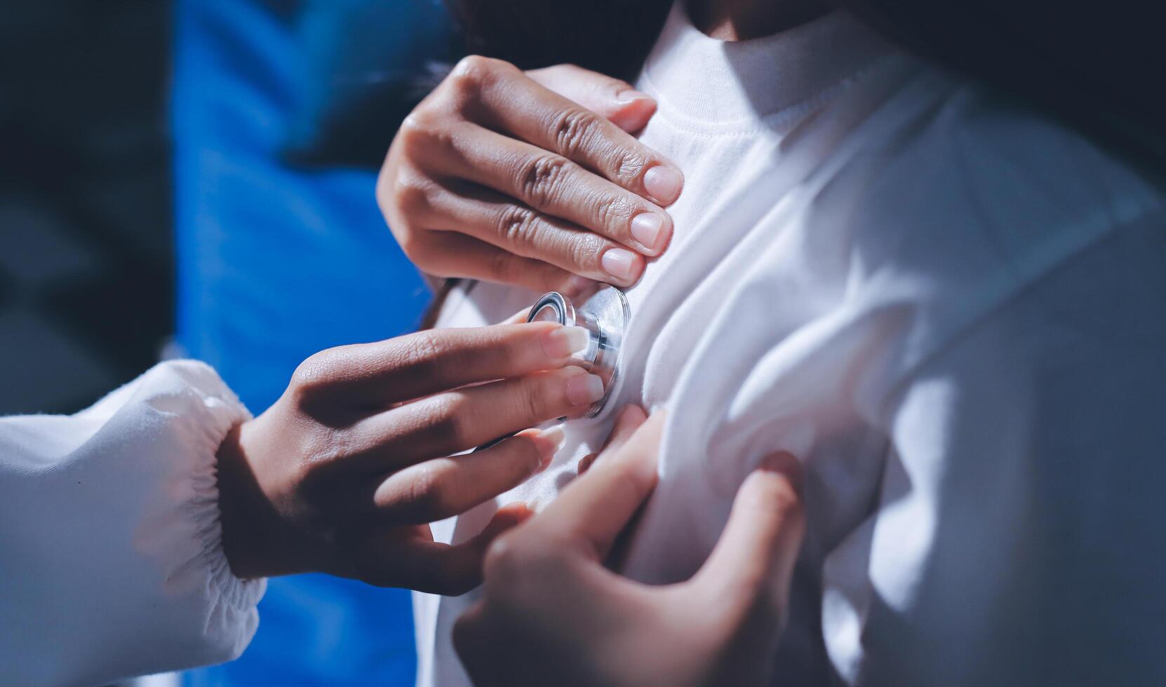 A doctor is putting a pacemaker into a patient's chest photo
