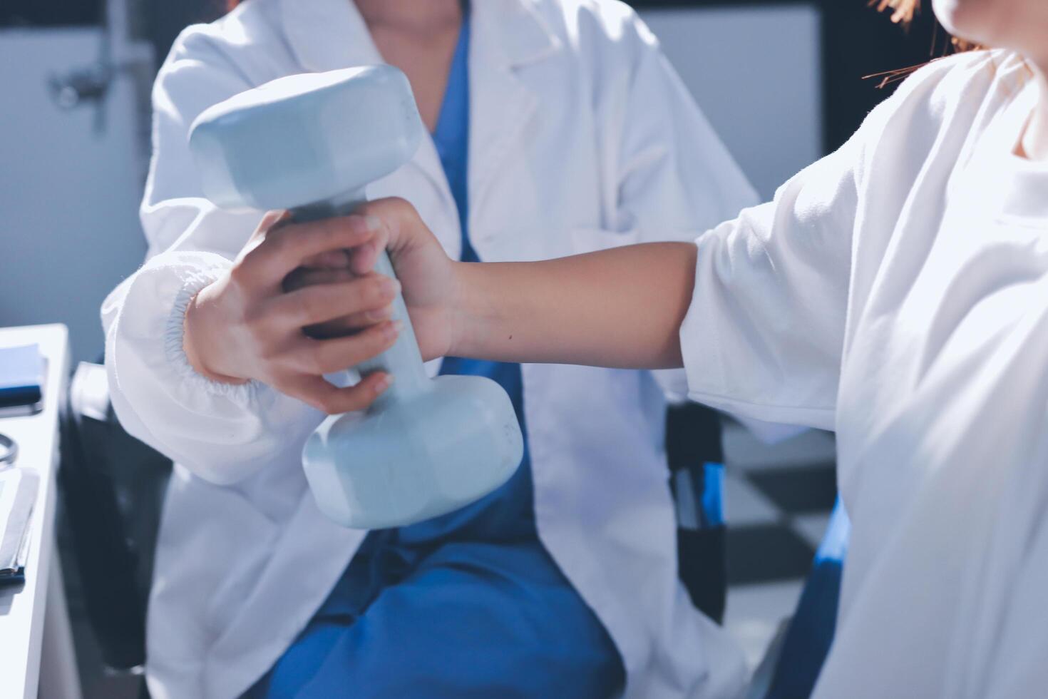 A woman is holding a dumbbell while another woman is sitting next to her photo