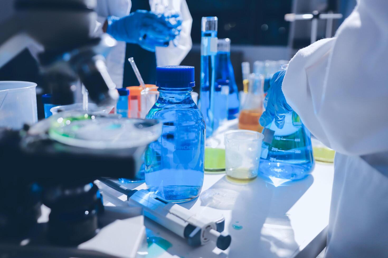 A laboratory with several bottles and a microscope photo