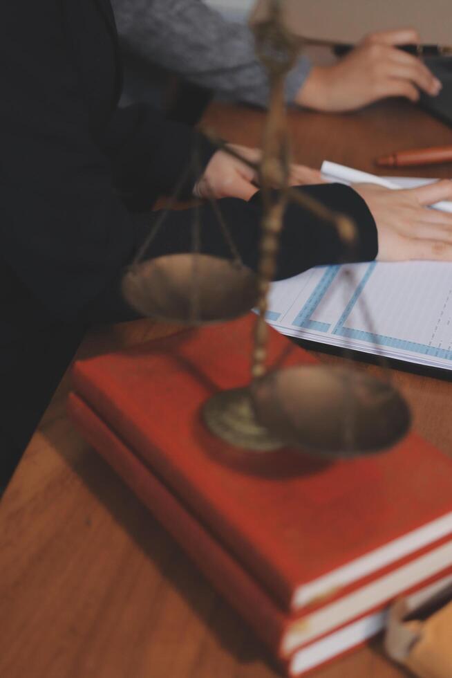 Lawyer's desk with a scale of justice and a notebook photo