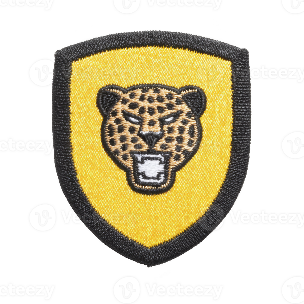 Shield shaped patch features embroidered leopard head on yellow background, outlined in black, symbolizing strength and agility png