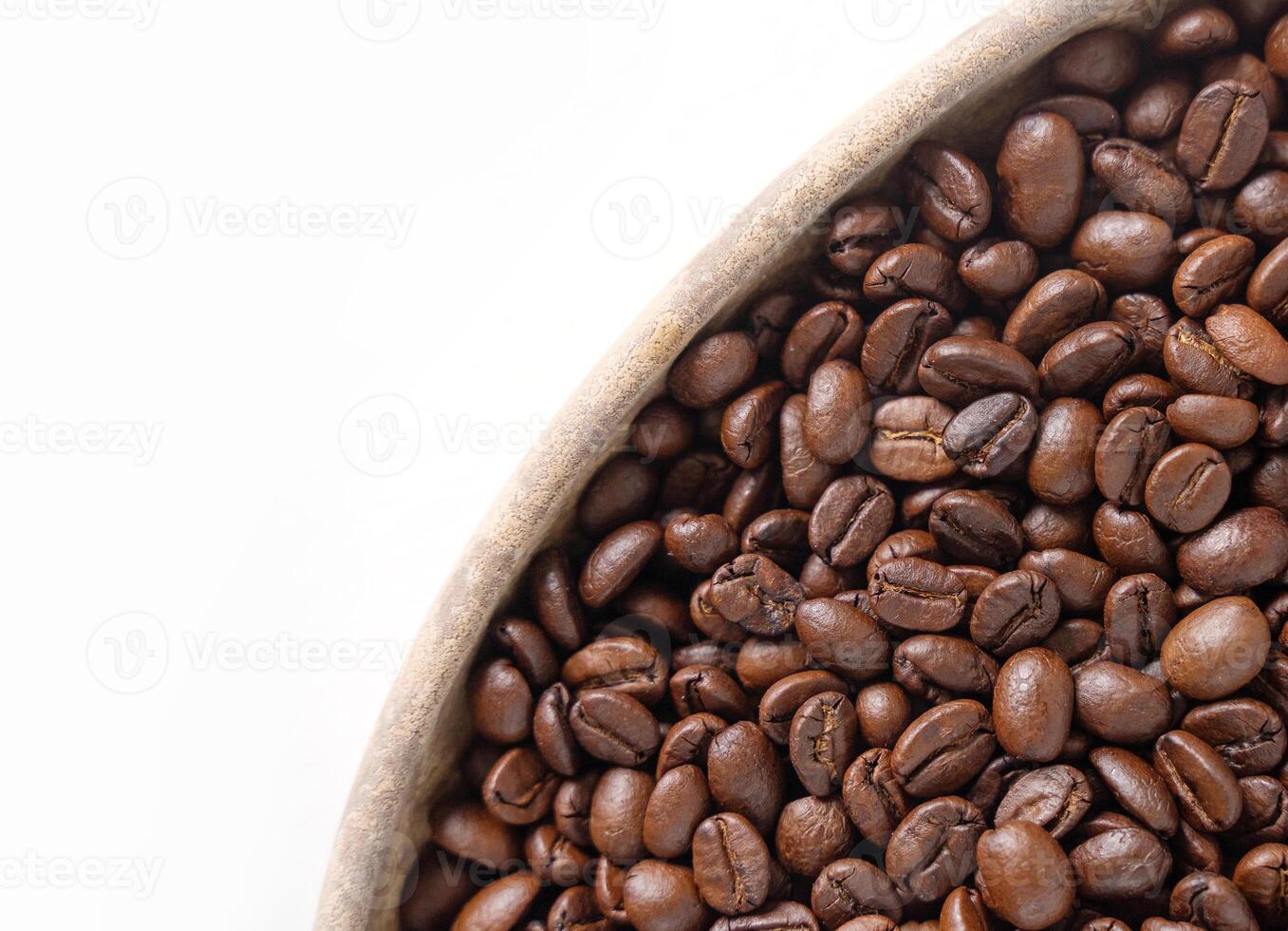 Coffee beans and wooden plate on white. Top view of brown roasted coffee beans. Close up image. photo