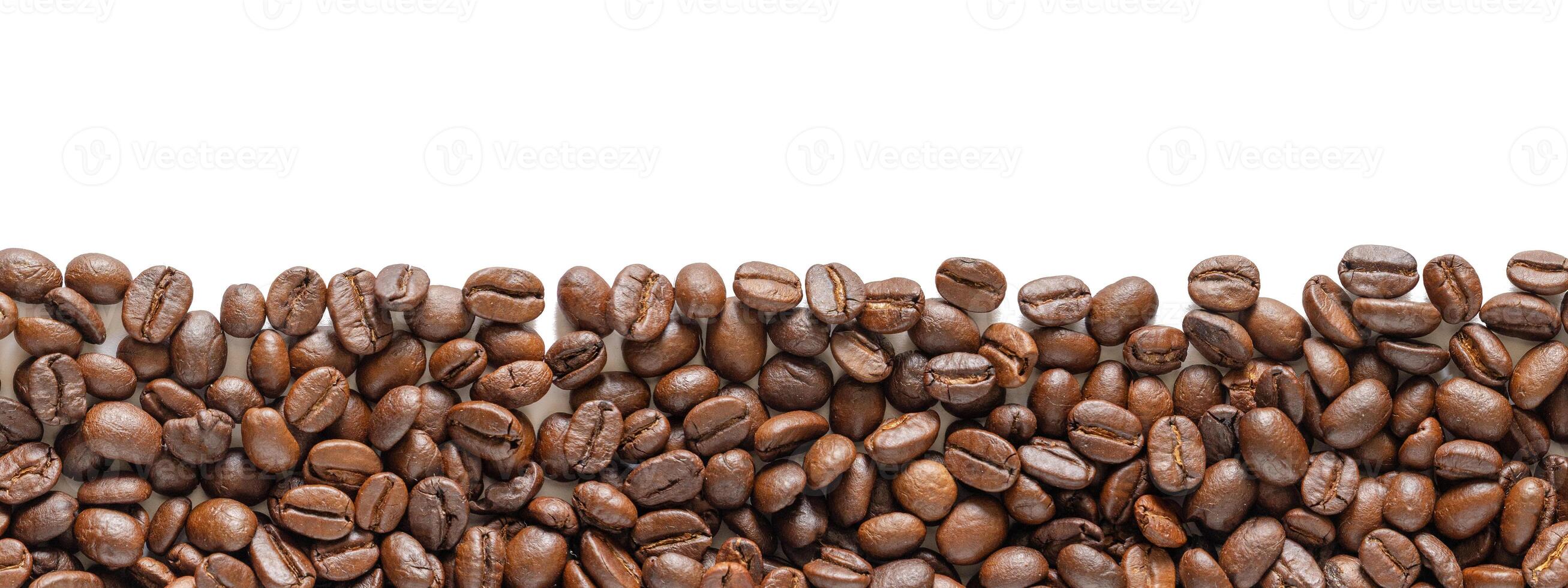 Roasted coffee beans on a white background. Coffee beans background with area for copy space. Close up image. photo