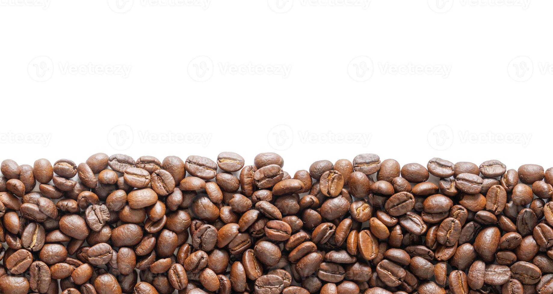 Roasted coffee beans on white background. Coffee beans background with area for copy space. Close up image. photo