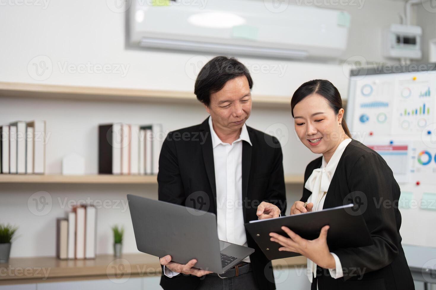 Team Collaboration and Engagement. Business professionals sharing insights with a laptop in a modern workspace. photo