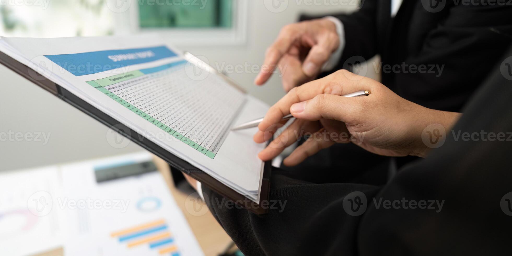 Data Review and Strategy Development. Business professionals analyzing financial data together. photo
