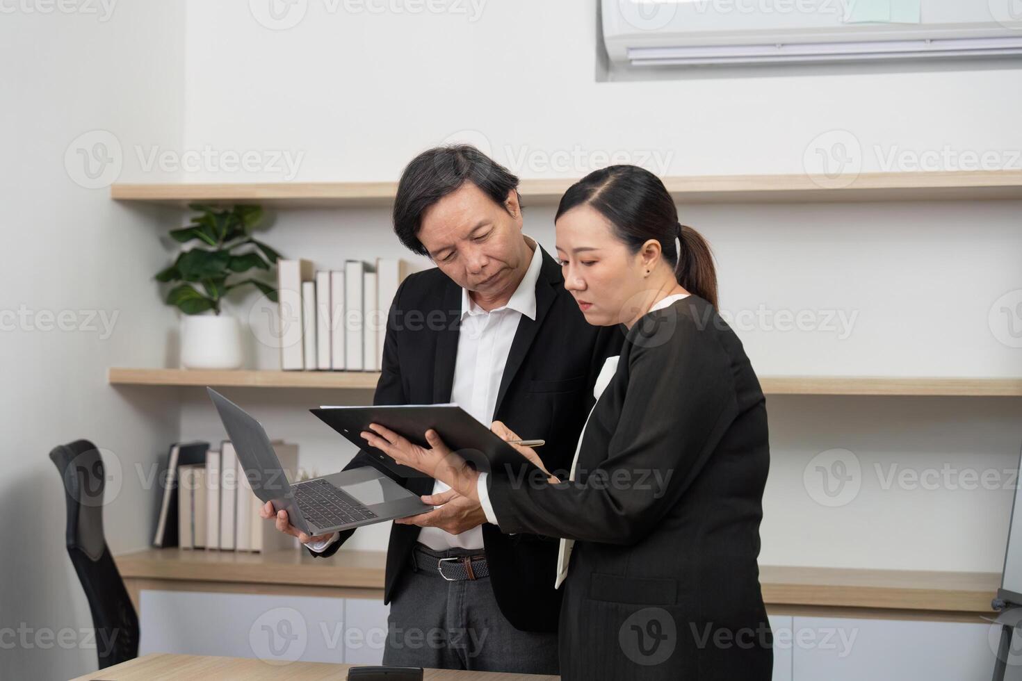 Business Collaboration and Communication. Professionals discussing project details with a laptop and tablet. photo