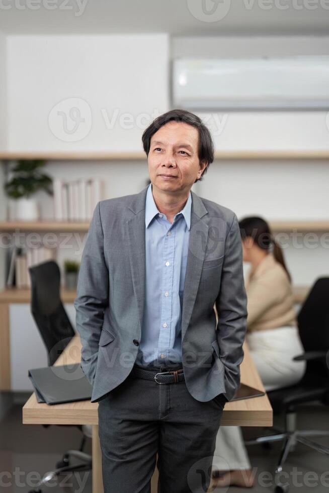 Professional Businessman in Office. Confident leader standing with arms crossed in a modern workspace. photo