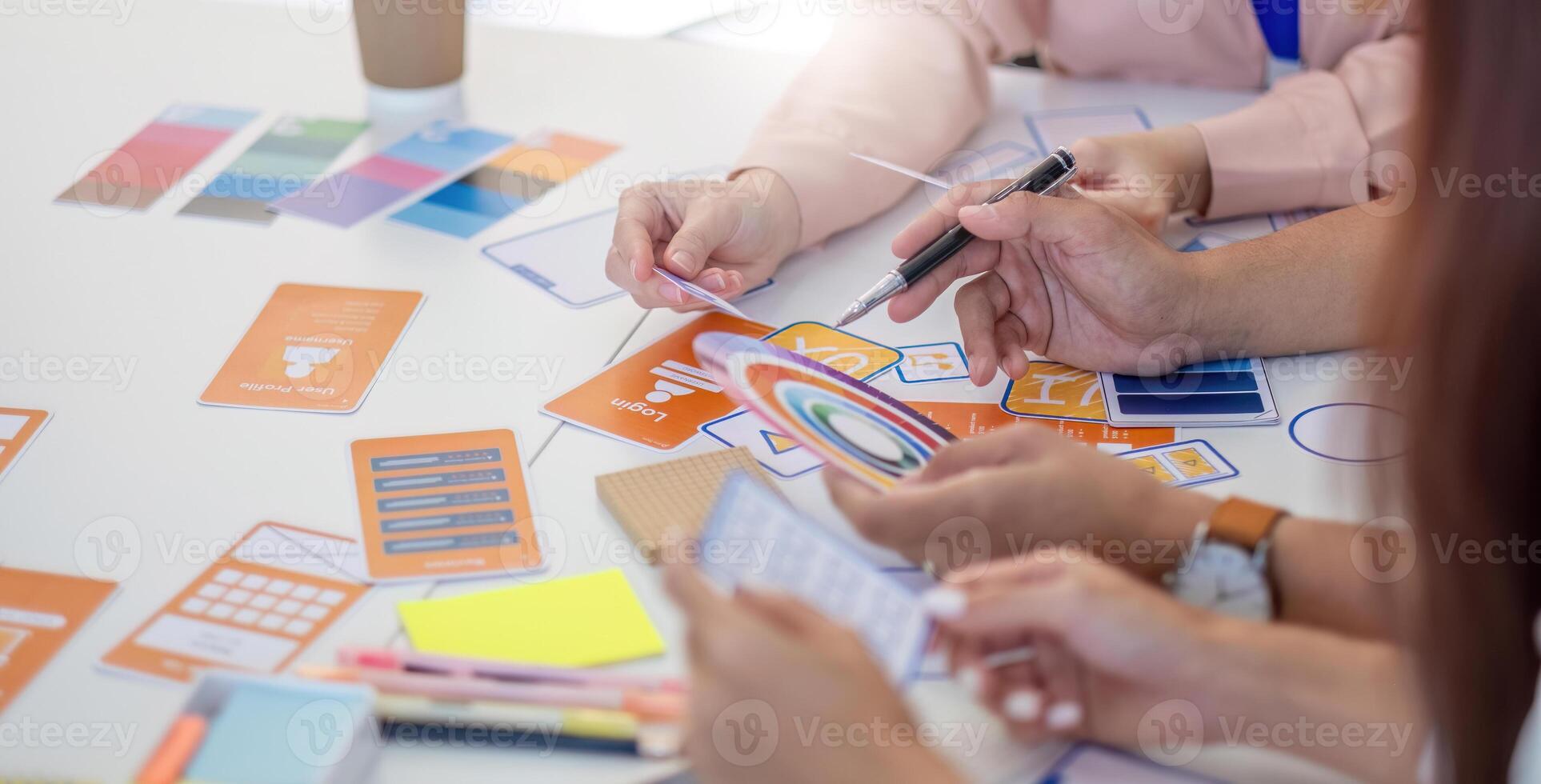 Team of Designers Collaborating. Professionals discussing layout concepts and color selections at a creative workspace. photo
