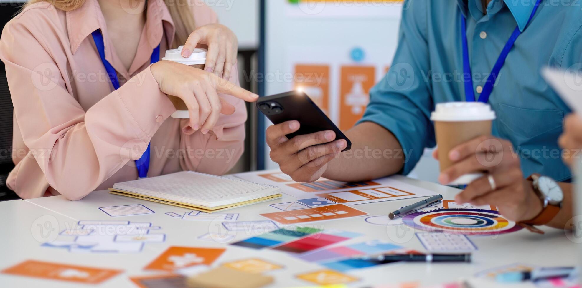 Design Team Engaging in Creative Process. Professionals analyzing designs and discussing ideas at a collaborative workspace. photo
