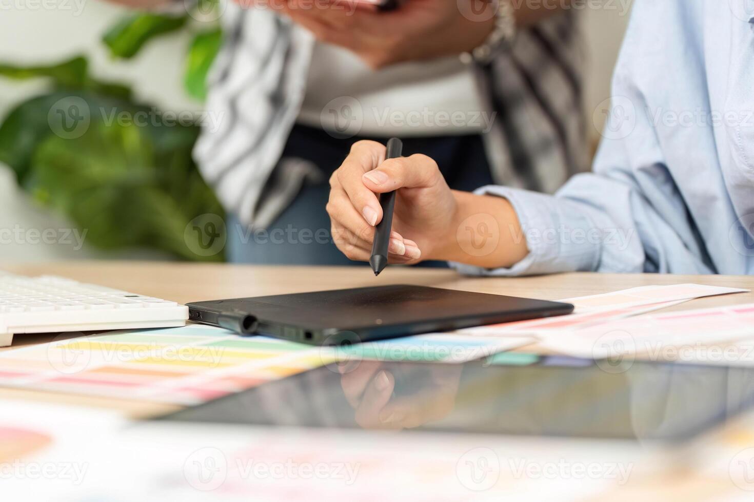 UX and UI Design Collaboration. Creative professionals brainstorming with digital tablet. photo