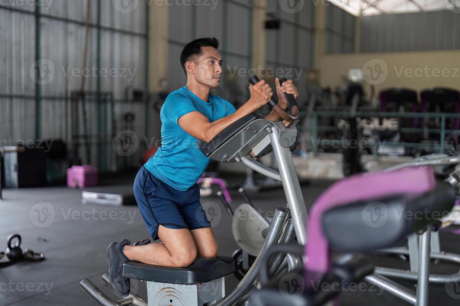 Fitness Enthusiast. Man performing workout on elliptical machine. photo