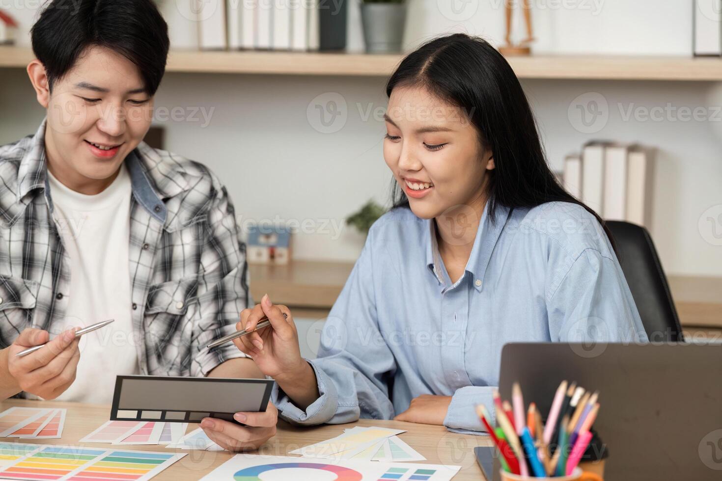 UX and UI Design Collaboration. Two designers discussing color palettes and layouts. photo