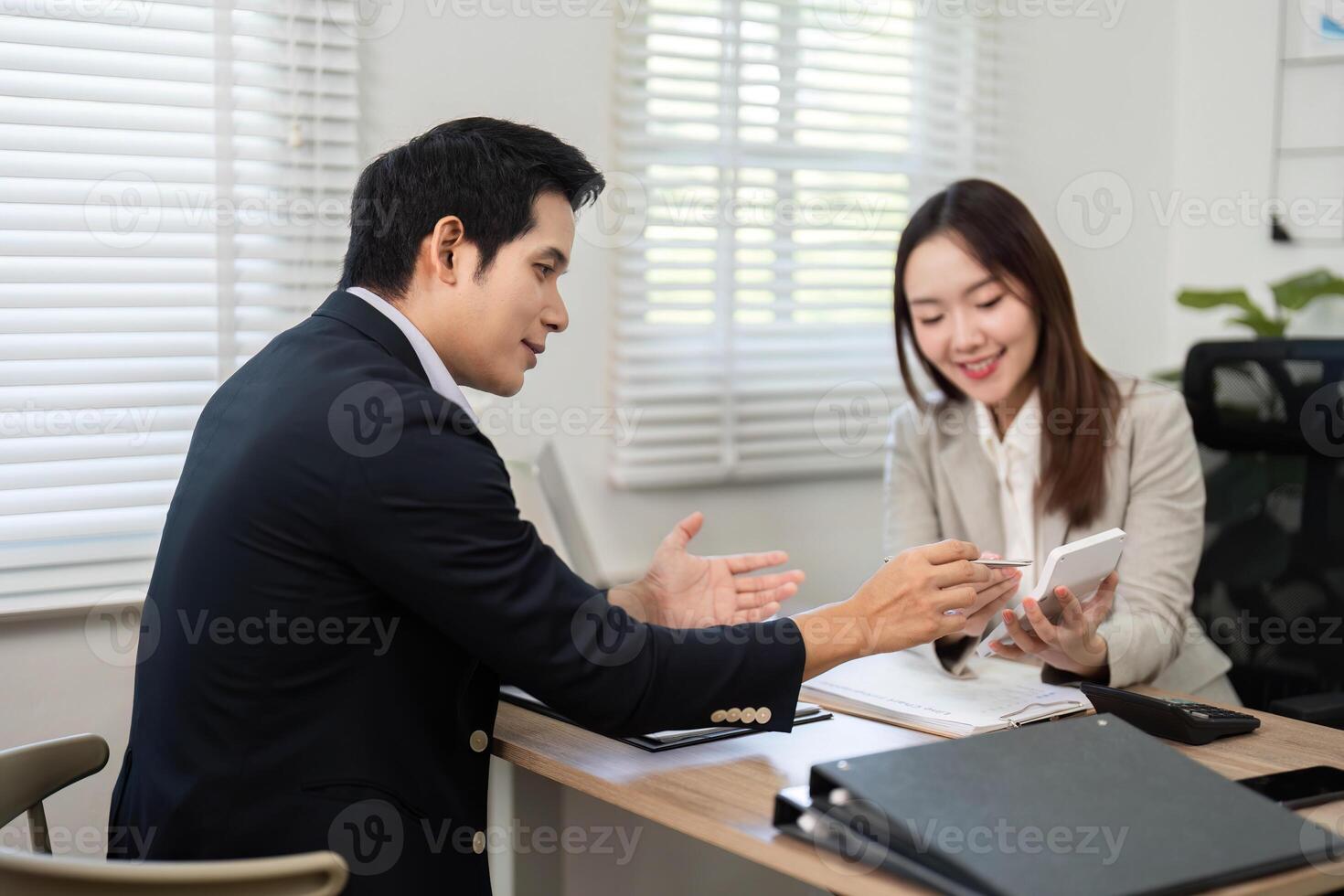 Financial Consultation. Advisor explaining investment strategies to a client in a modern office. photo