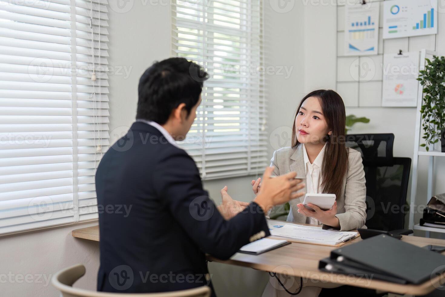 Financial Consultation. Engaging conversation between a financial advisor and client in a bright office. photo