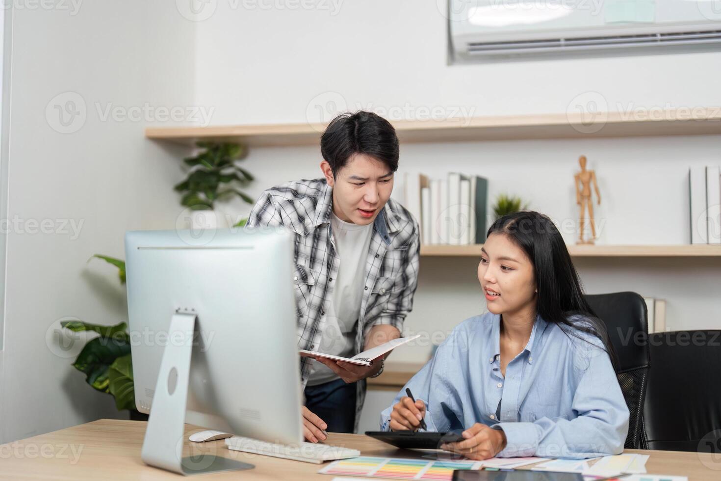 UX and UI Design Collaboration. Young designers discussing project ideas and color selections at a modern desk. photo