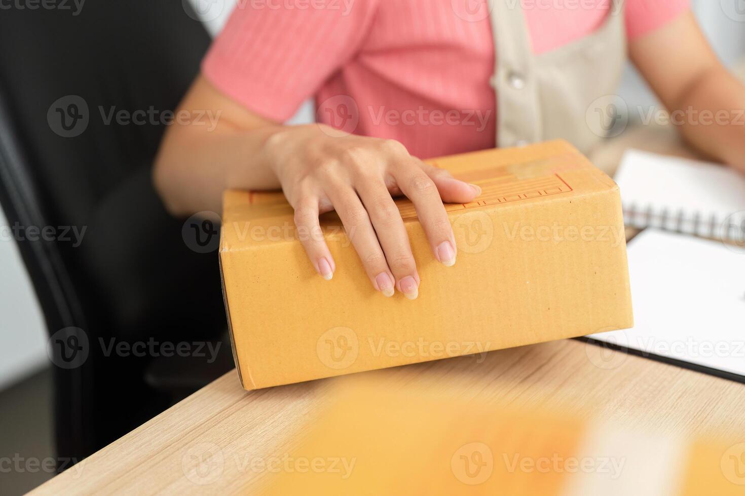 Small Business Operations. A woman handling packages in a microbusiness setting. photo