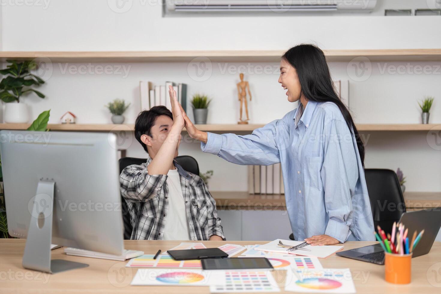 High-Five Moment in UX and UI Design. Designers celebrate a milestone with a joyful high-five. photo