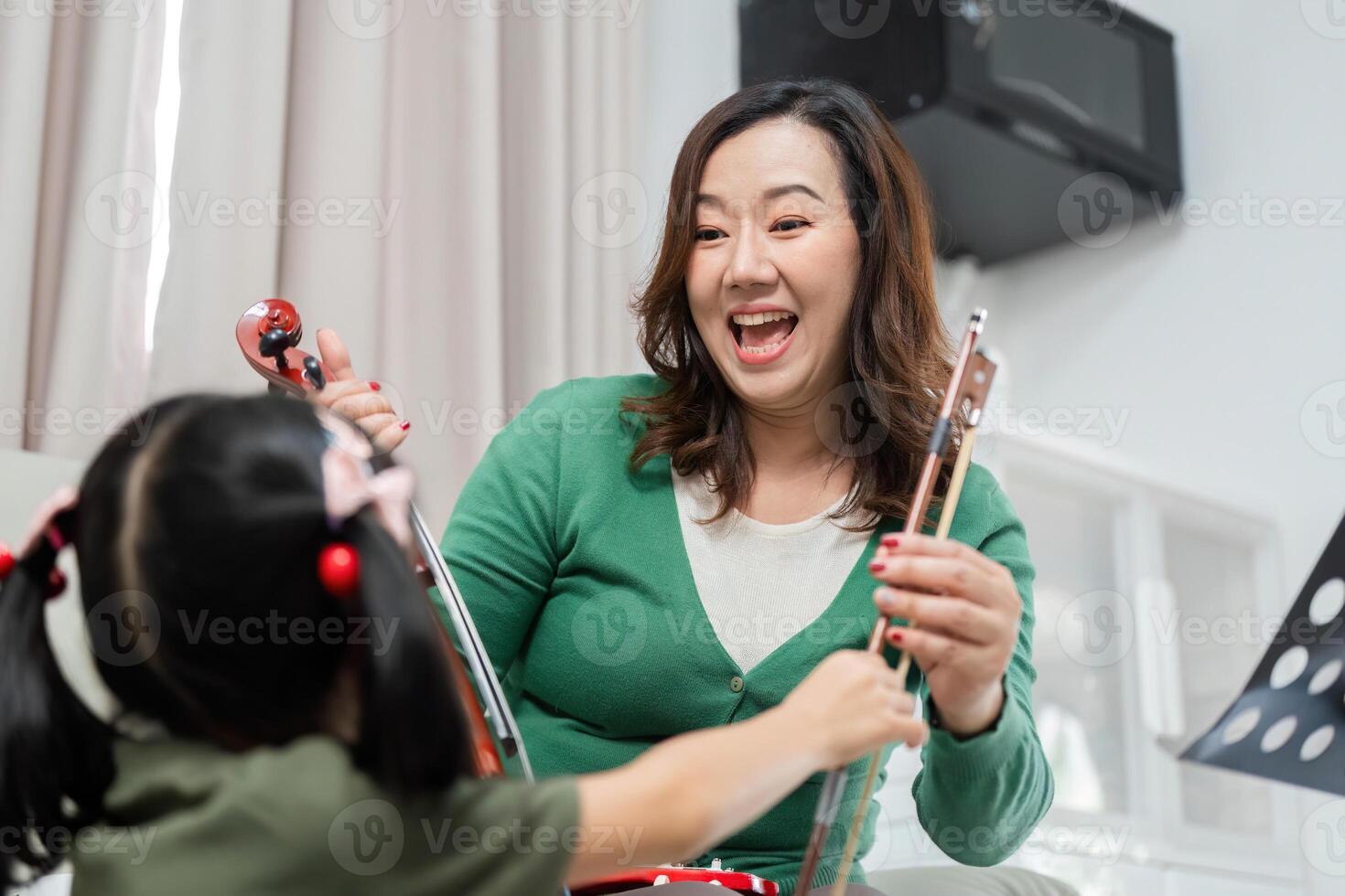 Music Education and Joyful Learning. A mother and daughter sharing a fun moment with musical instruments. photo