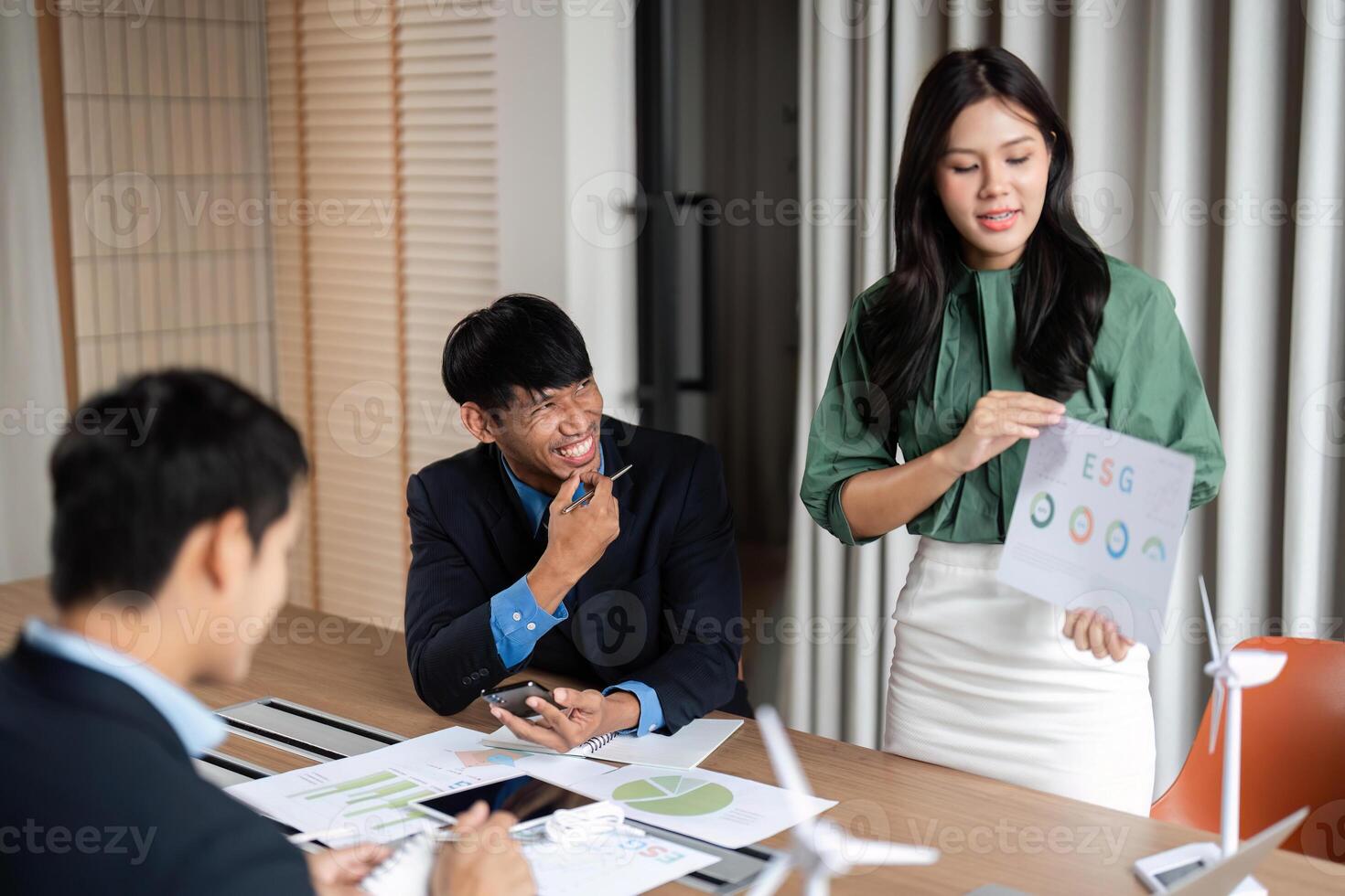 ESG Strategy Meeting. Team discussing sustainable practices and governance in a modern office. photo
