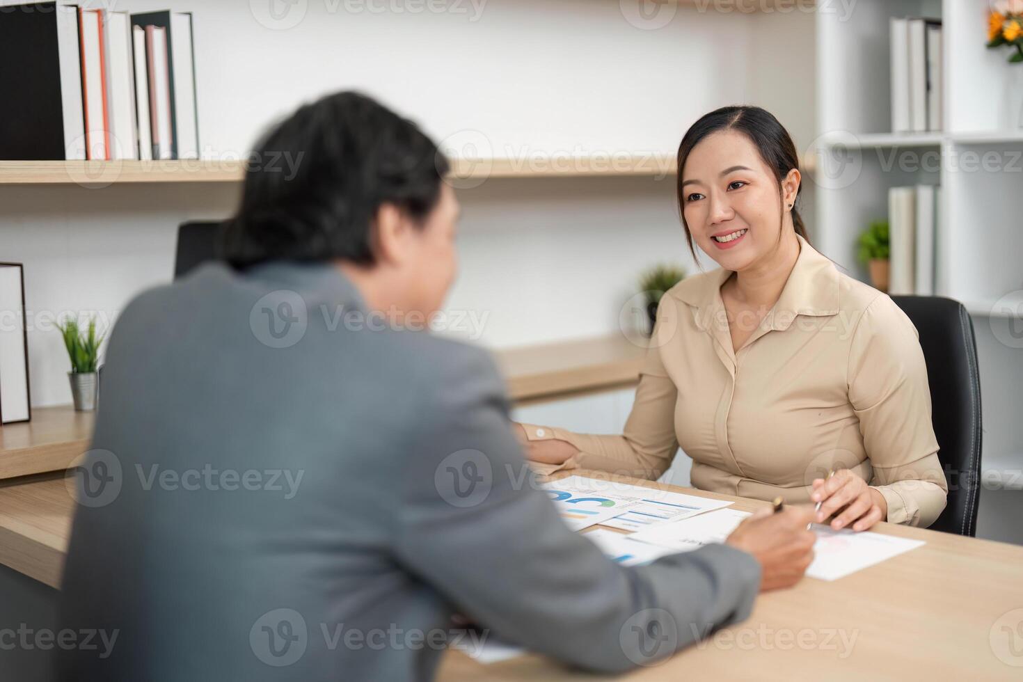 Professional Consultation and Data Review. Colleagues discussing performance metrics in a modern office environment. photo
