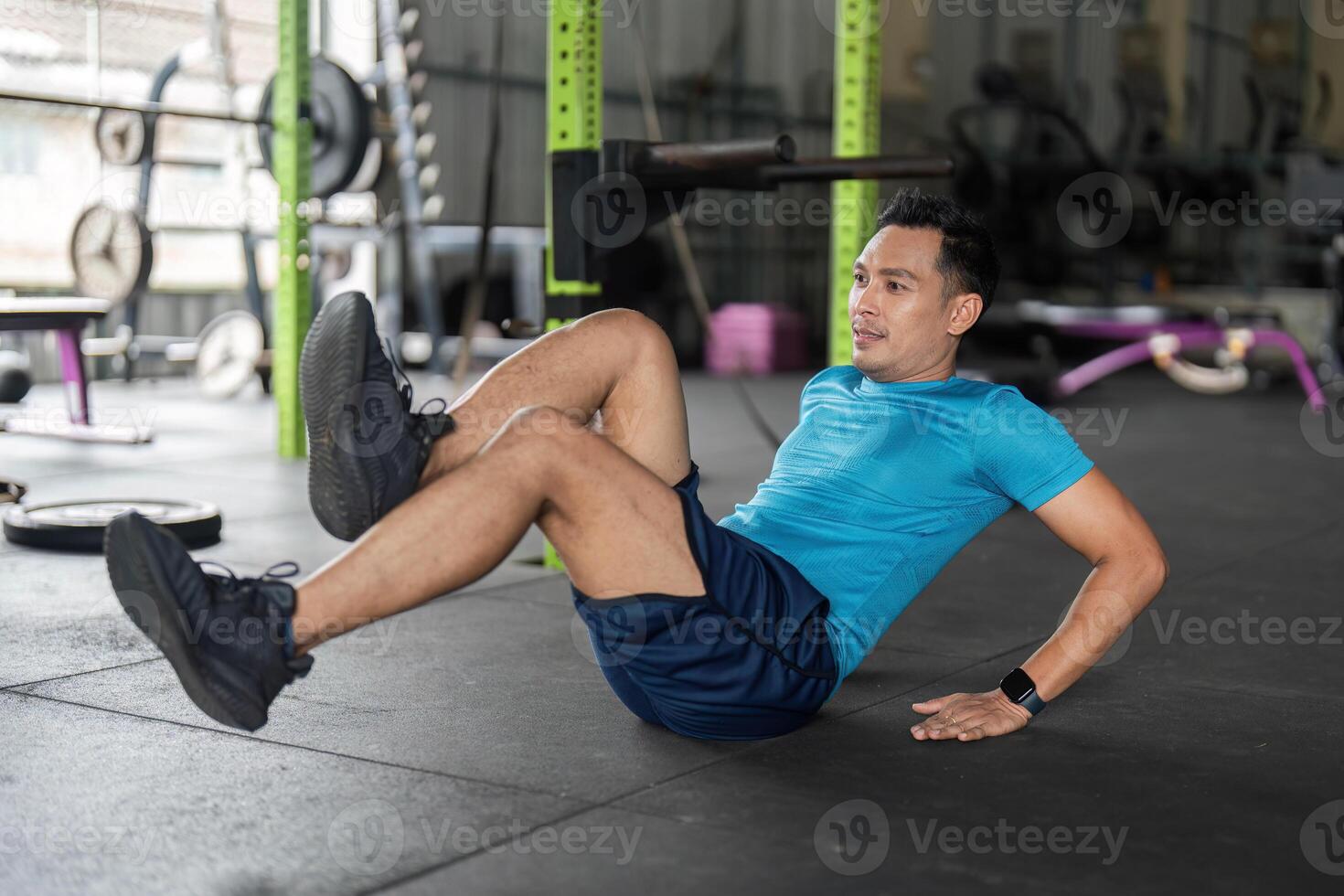 Fitness. Man Performing Bicycle Crunches in Gym photo