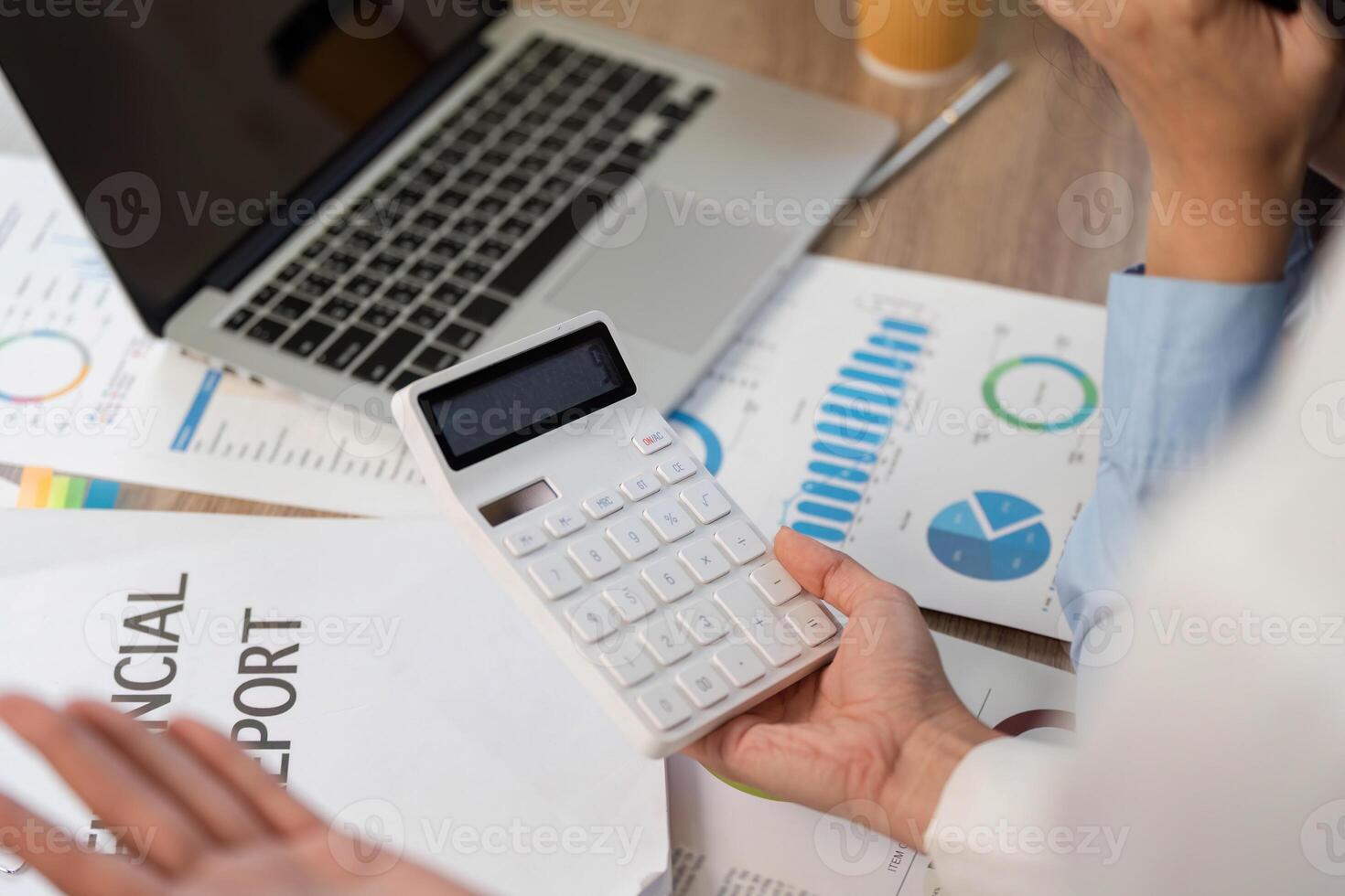 Financial Analysis. Close-up of a calculator and financial reports on a desk. photo