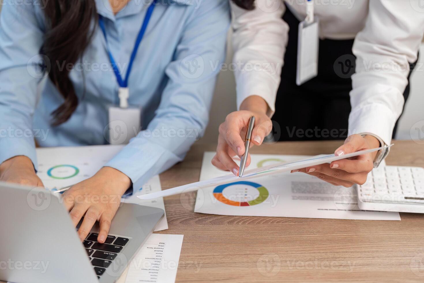 Data Analysis and Collaboration. Women working together on financial reports and strategies. photo