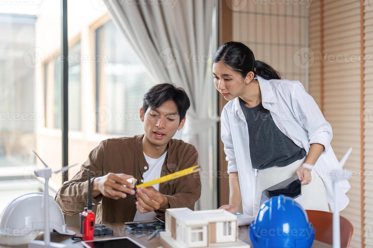 Sustainable Development and ESG. Architects discussing eco-friendly building models. photo