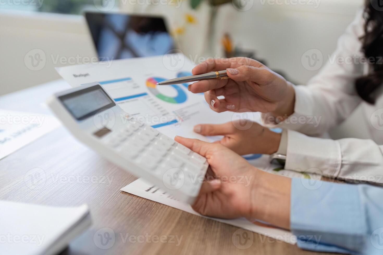 Financial Consultation. Professional discussing budget with calculator and documents. photo