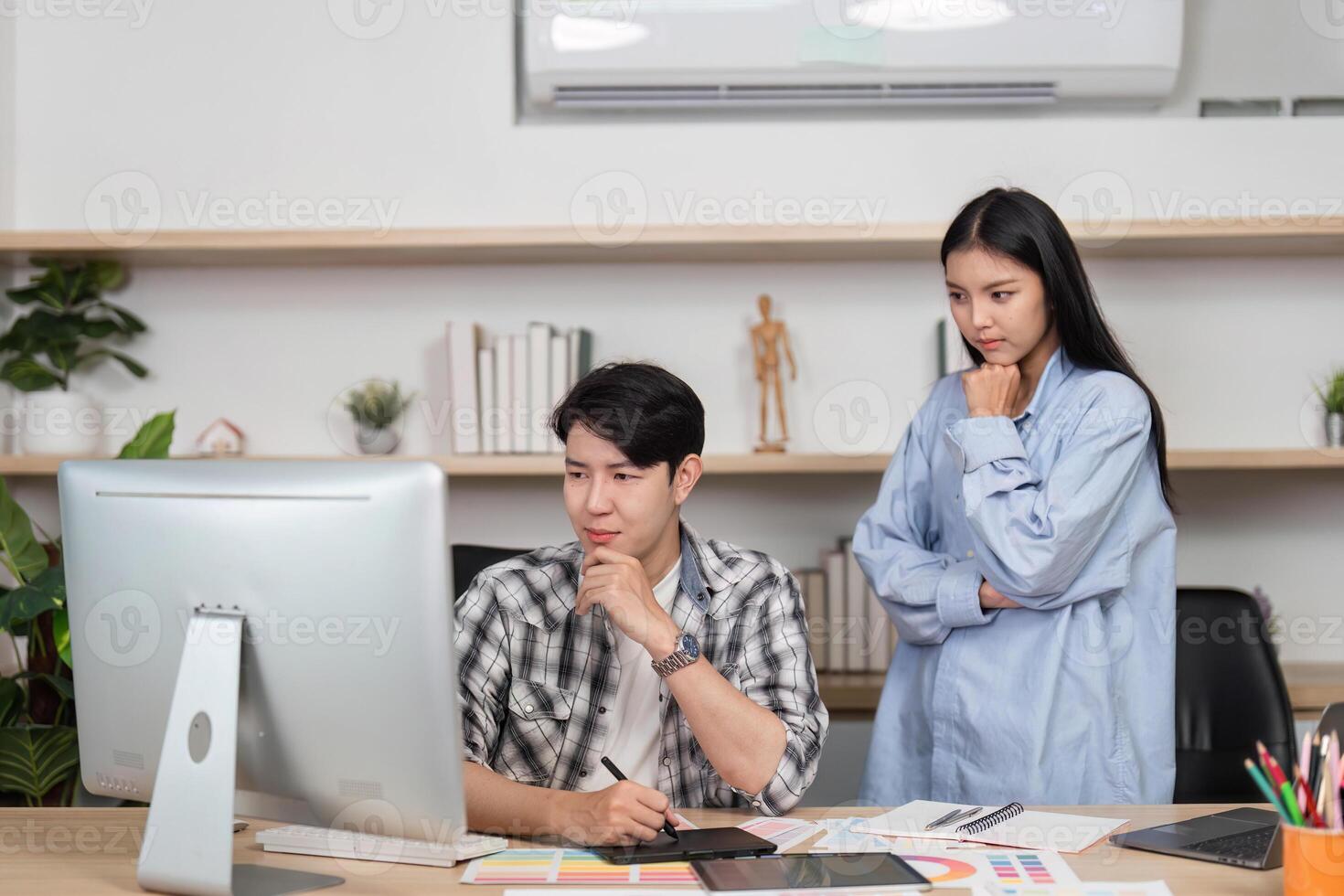 UX and UI Collaboration. Two designers discussing project ideas in a creative workspace. photo