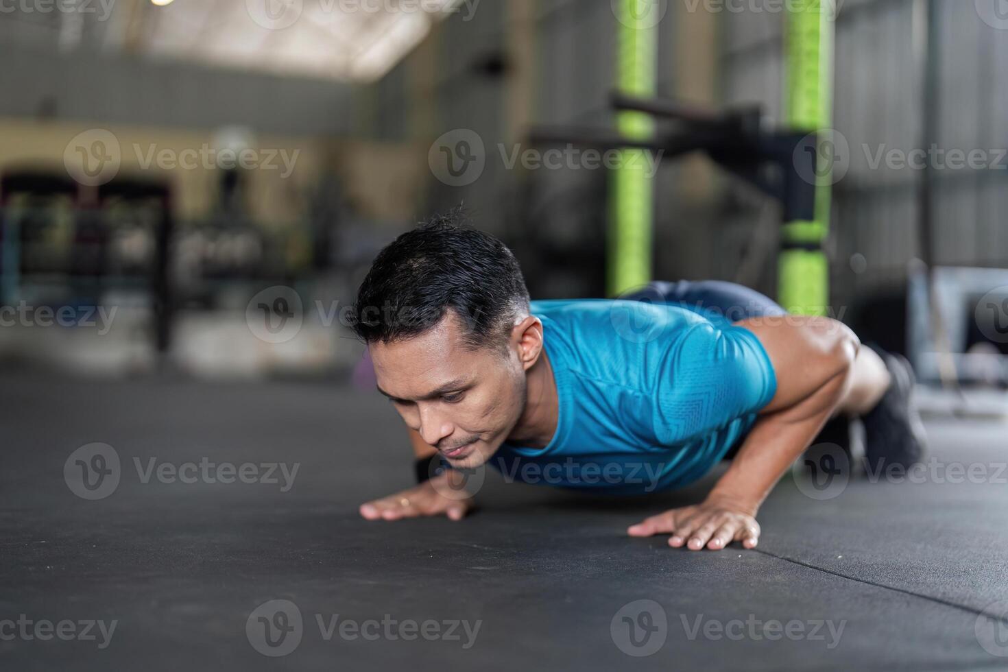 Man Engaged in Push-Up Exercise at Gym photo