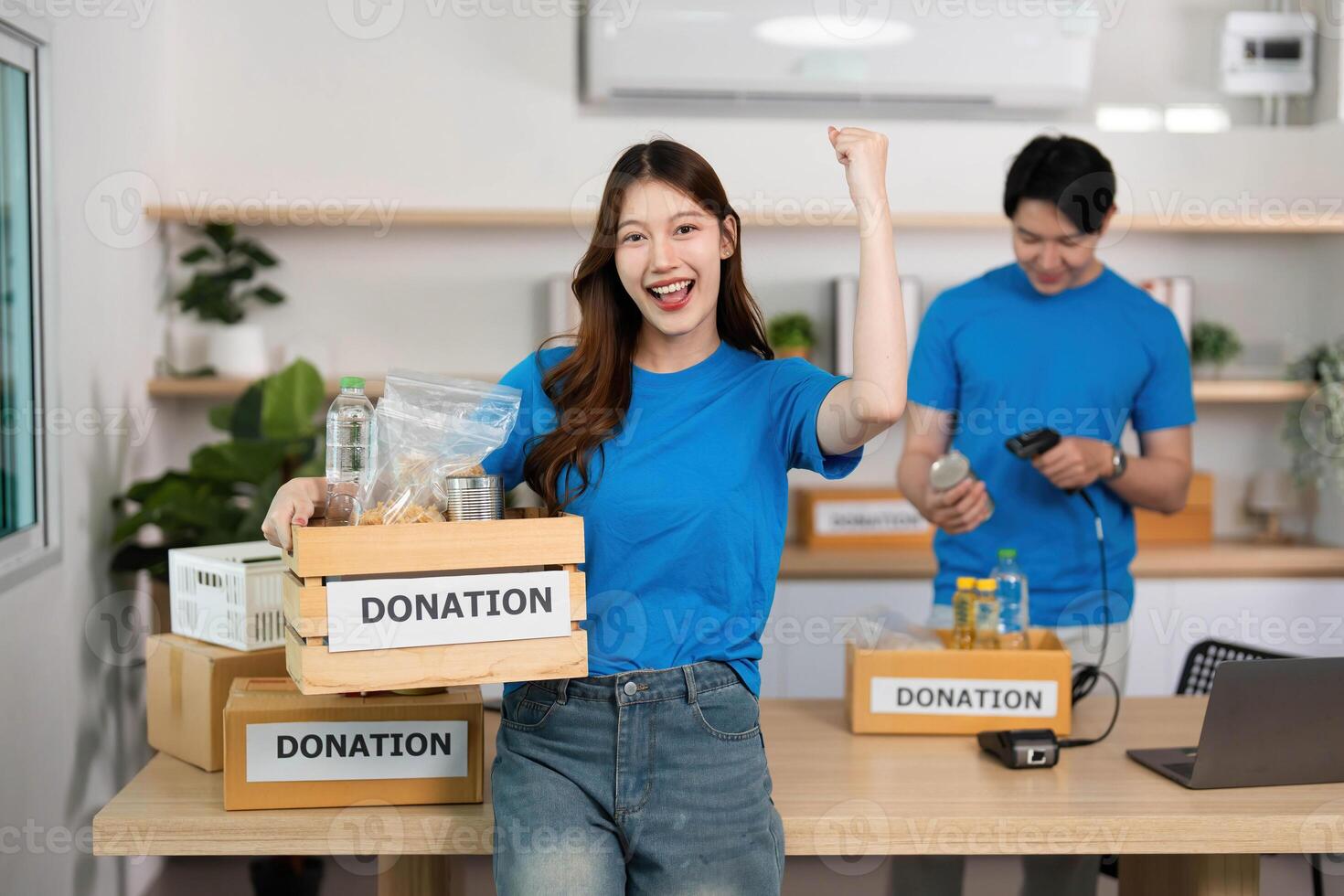 Donation Celebration. Volunteer expressing joy while holding a donation box. photo