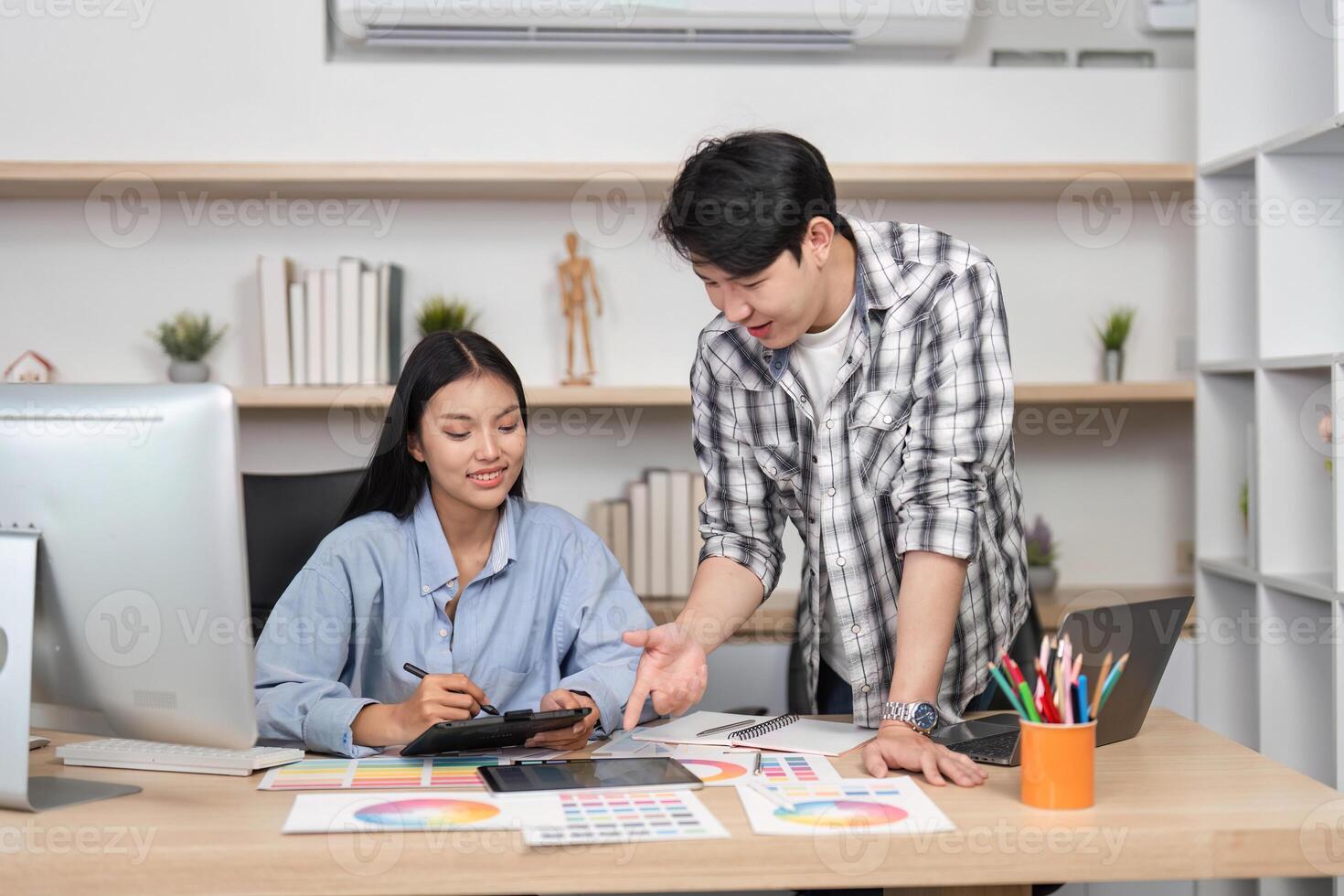 Collaborative UX and UI Design Session. Young professionals reviewing digital designs in a creative workspace. photo